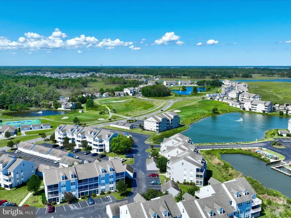 a view of a city with lots of residential buildings ocean and mountain view in back