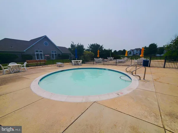 a view of swimming pool with outdoor seating and yard in back