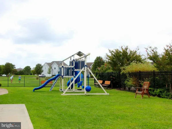 a view of a house with a backyard and a garden