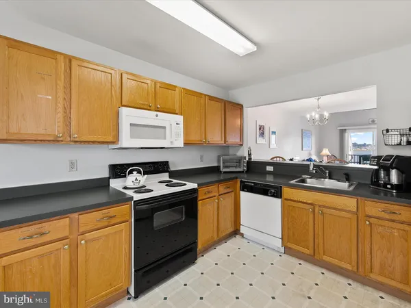 a kitchen with a sink a stove a refrigerator and cabinets