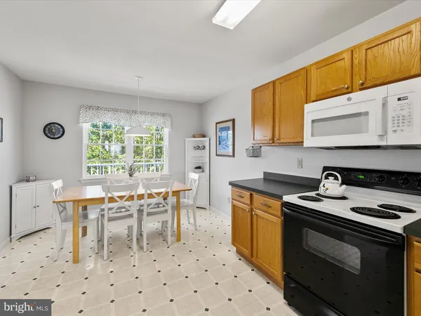 a view of a dining room with furniture and a large window