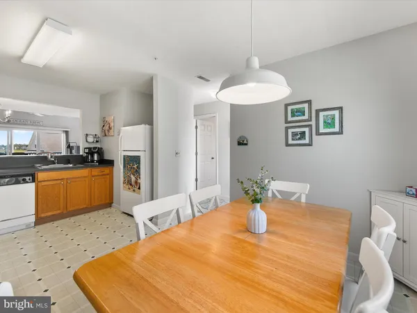 a view of a dining room with furniture and chandelier