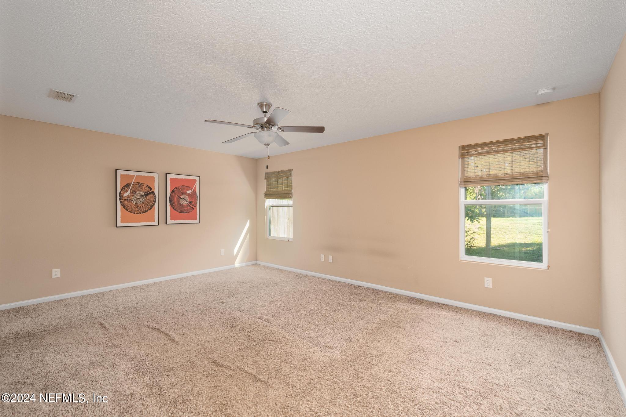 9890 Fraser Road Jacksonville, FL 32246 - Photo 12 of 23 an empty room with windows and fan
