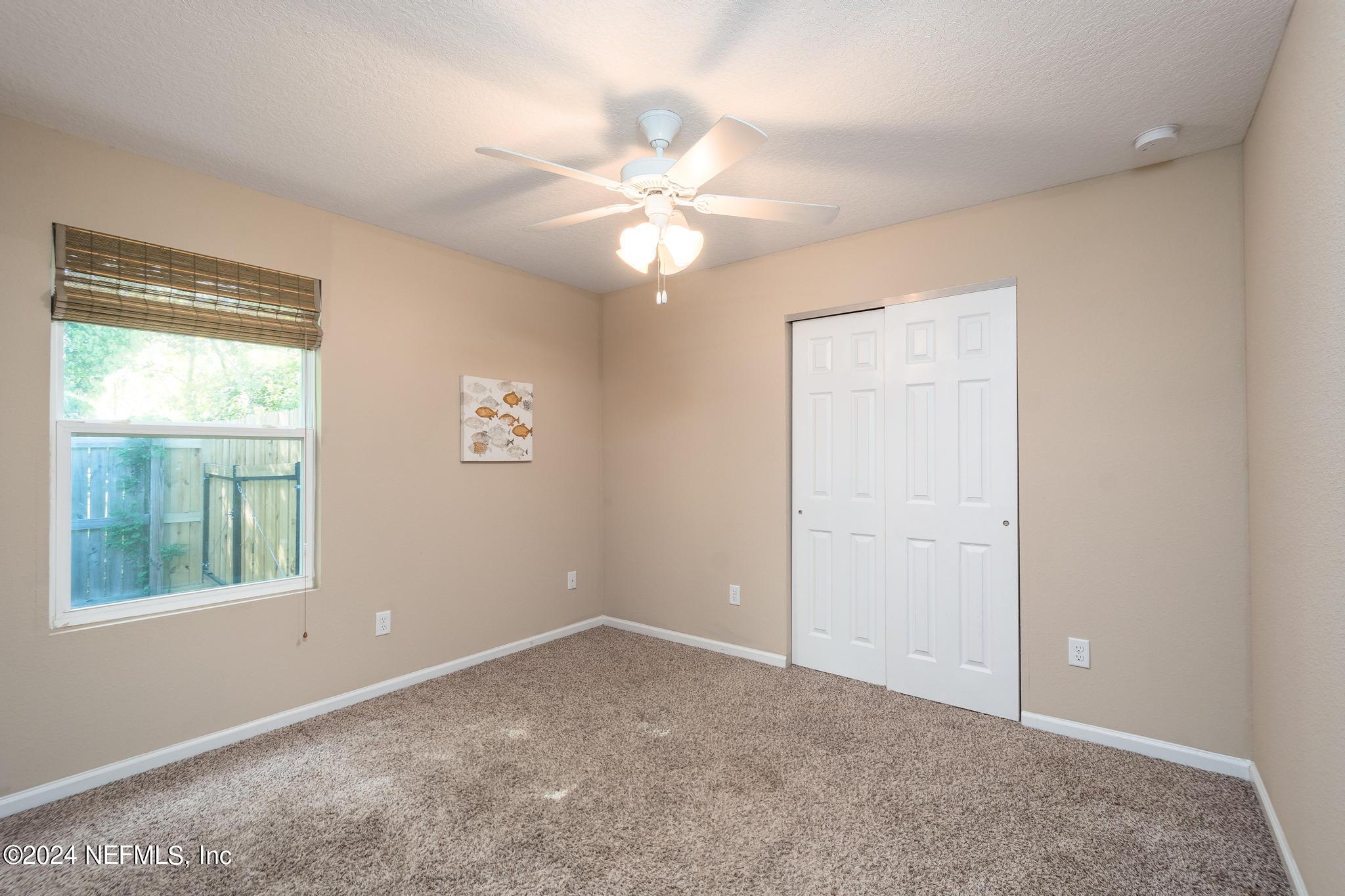 9890 Fraser Road Jacksonville, FL 32246 - Photo 17 of 23 an empty room with windows and fan