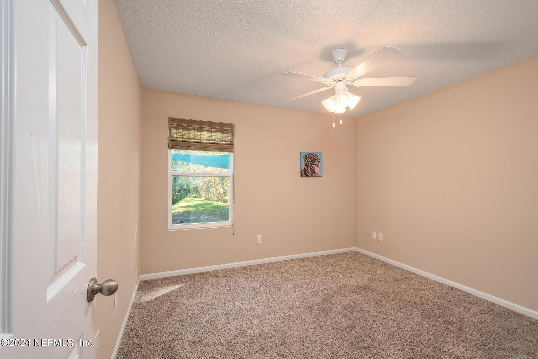 9890 Fraser Road Jacksonville, FL 32246 - Photo 19 of 23 an empty room with windows and fan