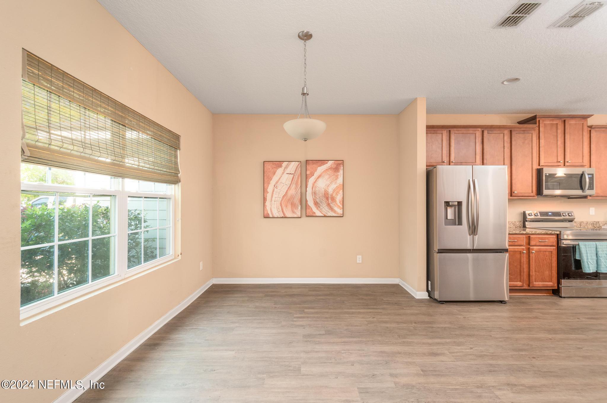 9890 Fraser Road Jacksonville, FL 32246 - Photo 4 of 23 a kitchen with stainless steel appliances granite countertop a refrigerator and a window