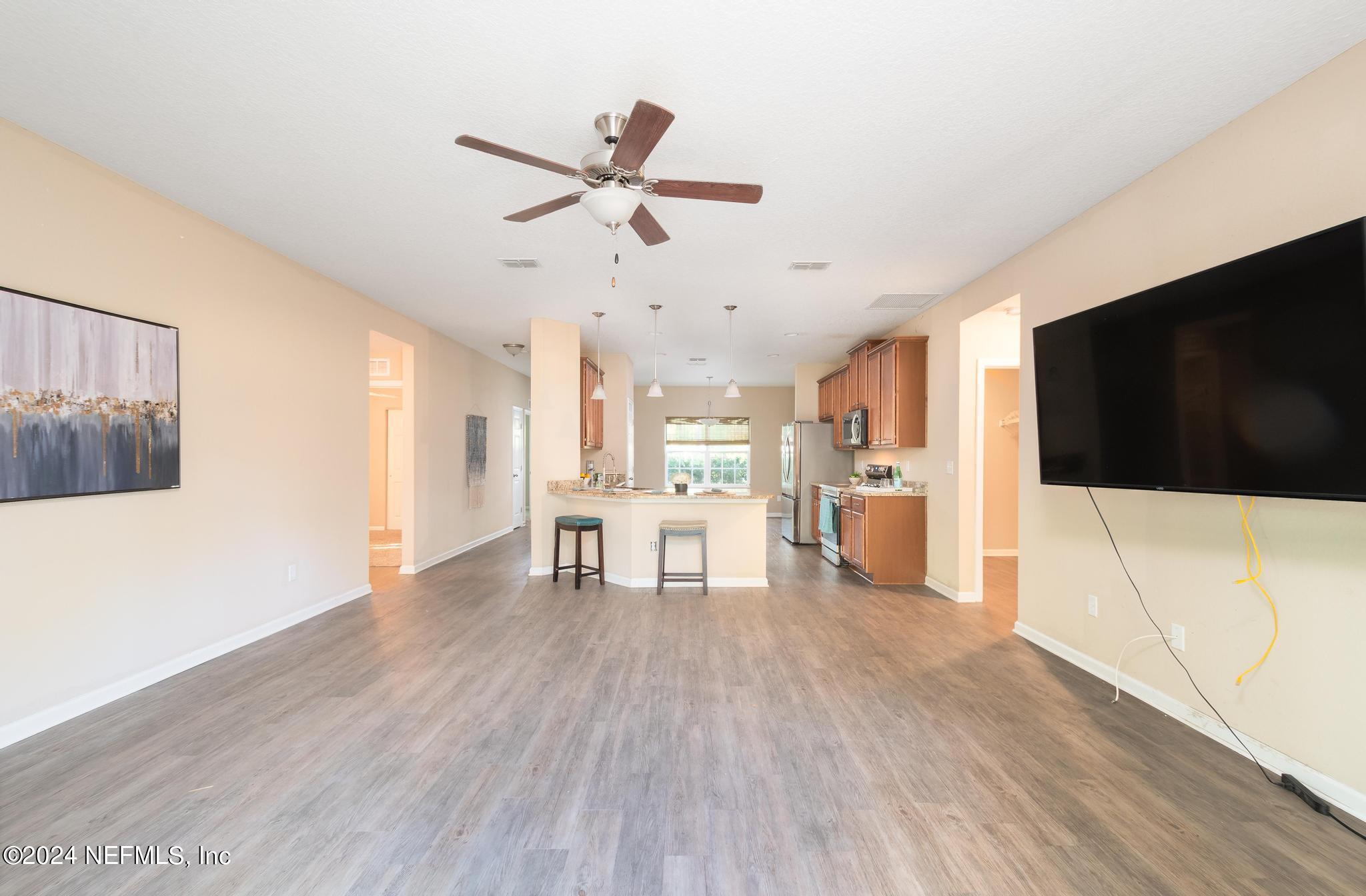 9890 Fraser Road Jacksonville, FL 32246 - Photo 9 of 23 a living room with stainless steel appliances furniture and a flat screen tv