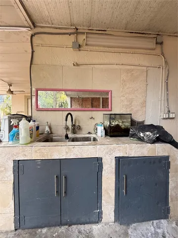 a kitchen with a sink a stove and cabinets