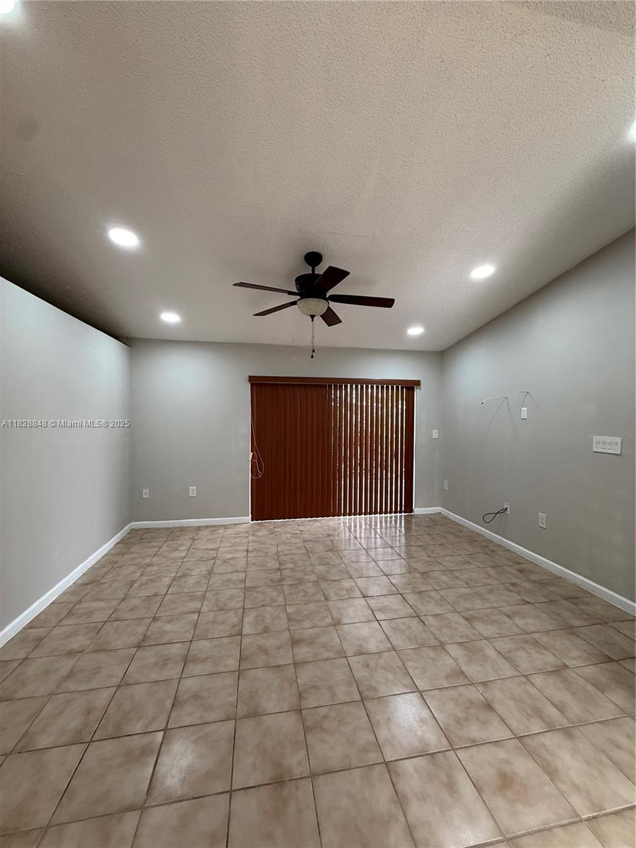 19926 Northwest 67th Place Hialeah, FL 33015 - Photo 5 of 21 a view of an empty room with a ceiling fan