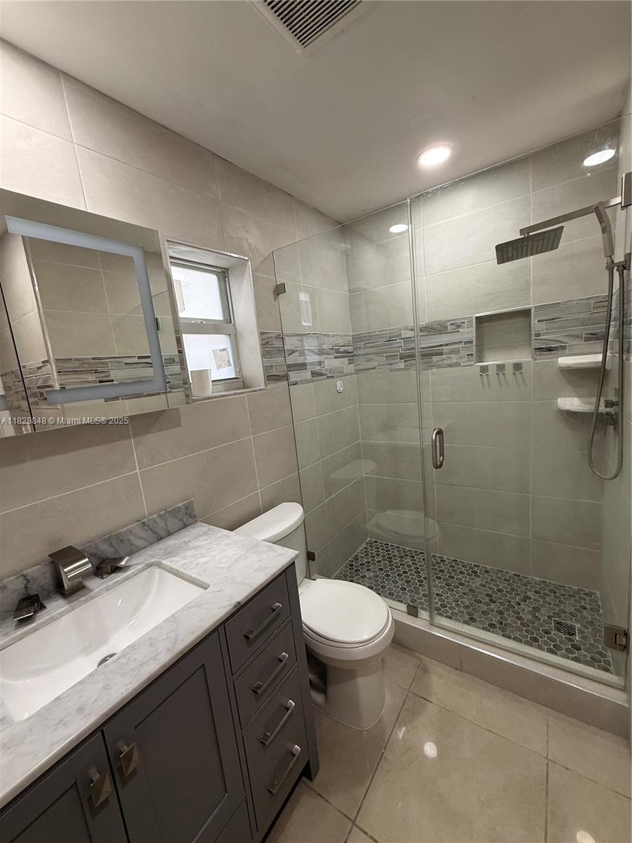 19926 Northwest 67th Place Hialeah, FL 33015 - Photo 6 of 21 a bathroom with a sink a toilet and shower