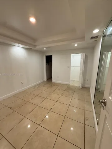 a view of a livingroom with an empty space and a window