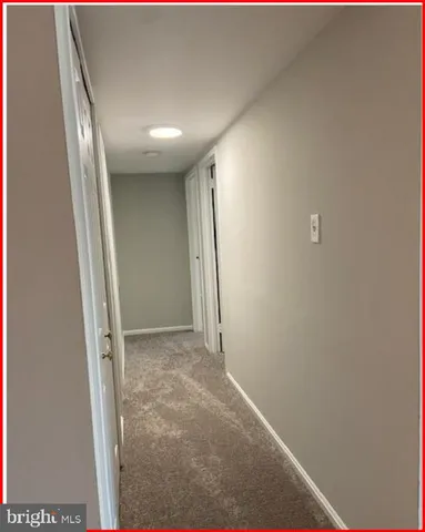 a view of an empty room with glass door