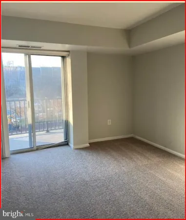 a bathroom with a toilet and a mirror