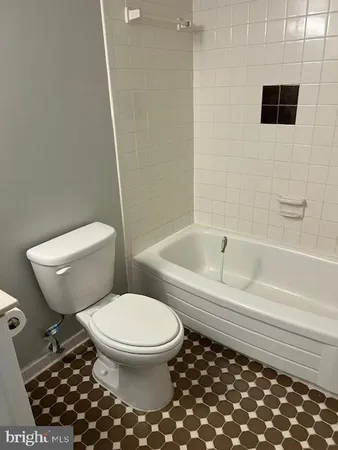a view of a big room with windows and chandelier