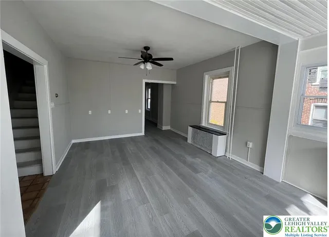 wooden floor in an empty room with a window