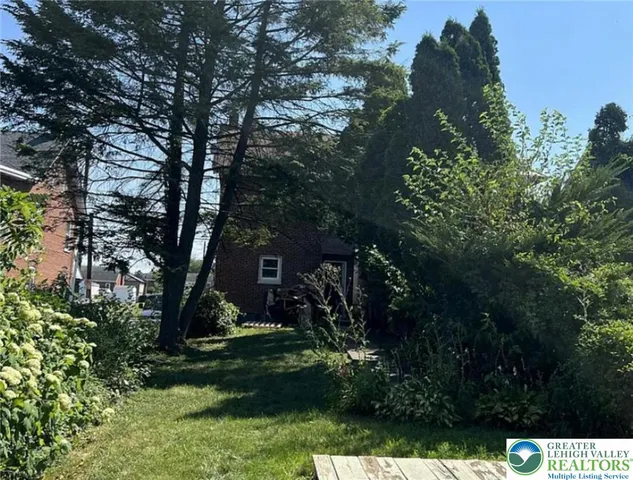 a view of a tree in front of a house
