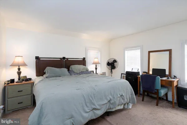 a living room with furniture a flat screen tv and a window