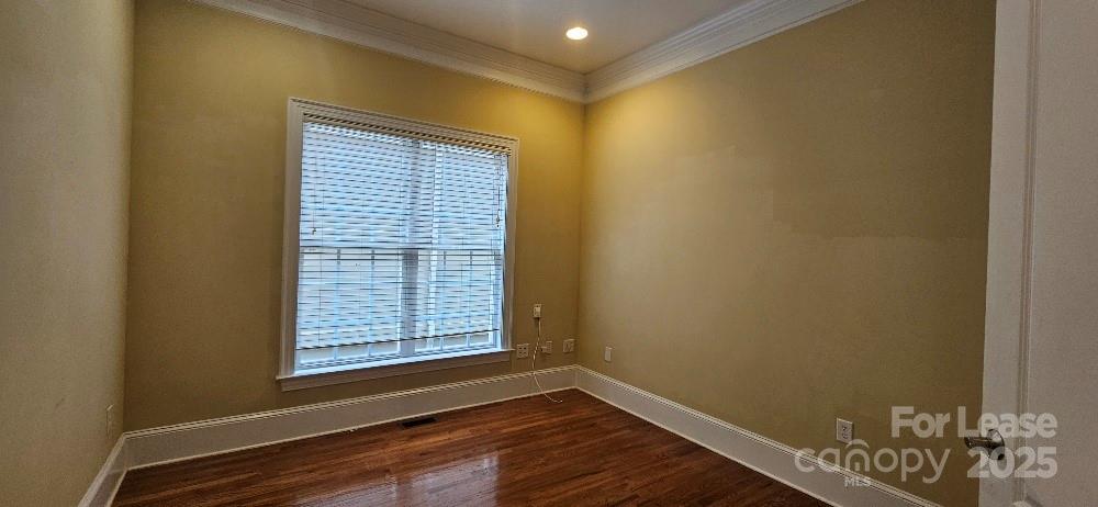 6926 Linkside Court Charlotte, NC 28277 - Photo 18 of 24 a view of an empty room with wooden floor and a window