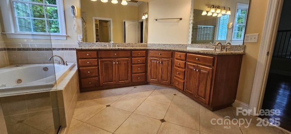 6926 Linkside Court Charlotte, NC 28277 - Photo 24 of 24 a bathroom with a tub sink and mirror