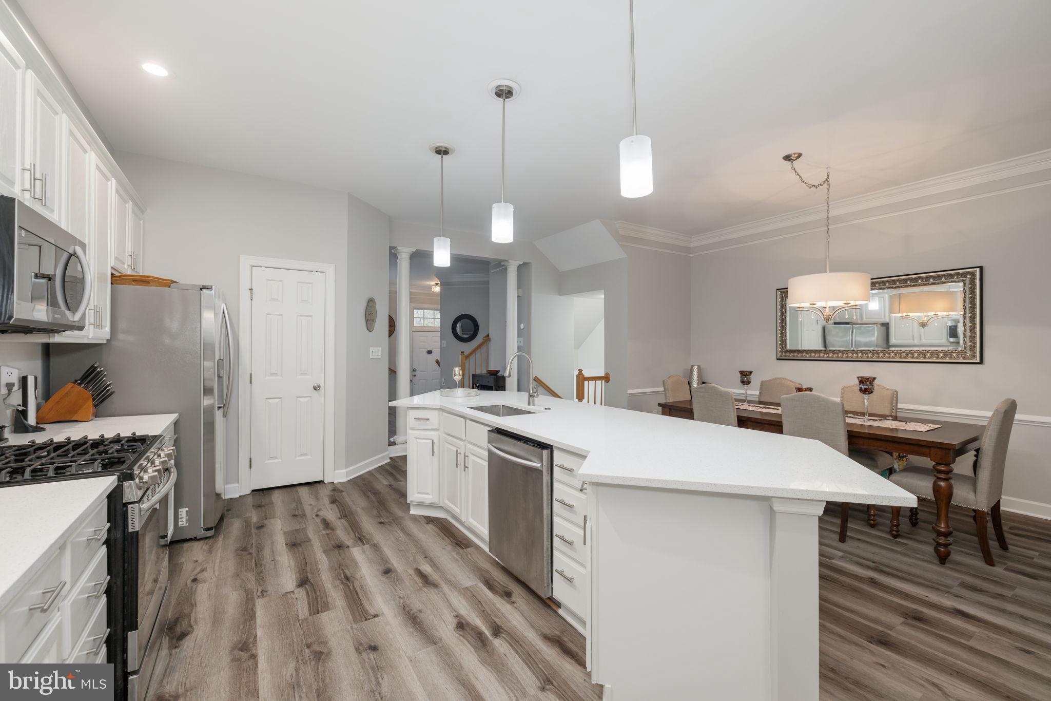 6337 Simmer Circle Springfield, VA 22150 - Photo 14 of 50 a large kitchen with a table and chairs in it