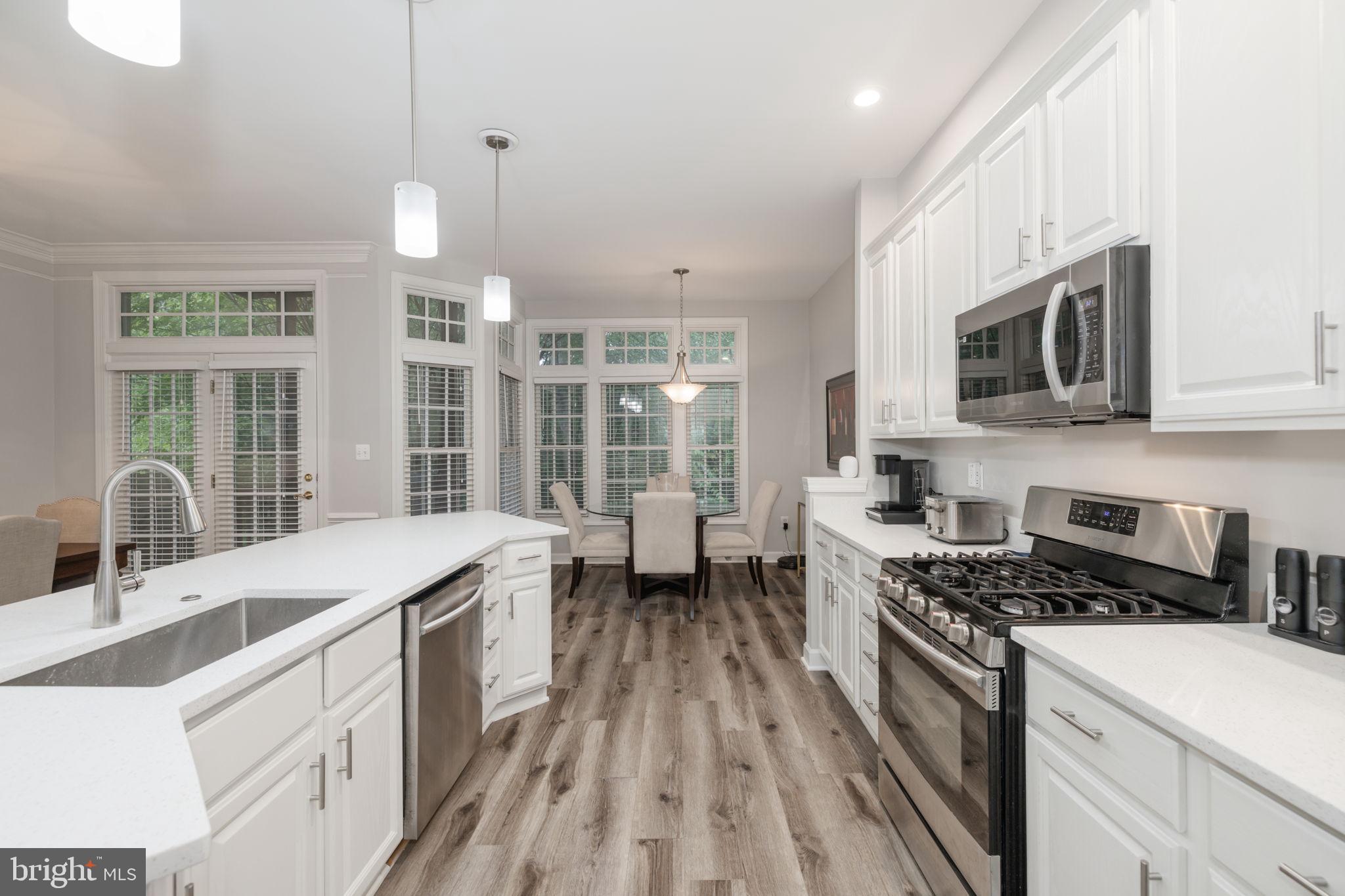 6337 Simmer Circle Springfield, VA 22150 - Photo 15 of 50 a kitchen with granite countertop a sink a counter space appliances and cabinets