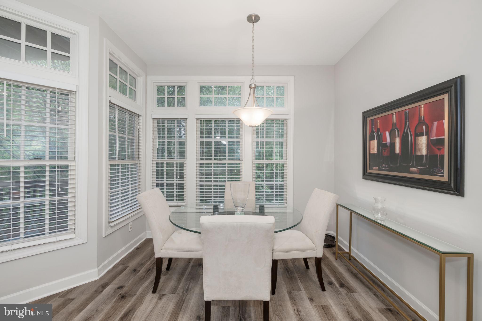 6337 Simmer Circle Springfield, VA 22150 - Photo 16 of 50 a dining room with furniture a chandelier and wooden floor