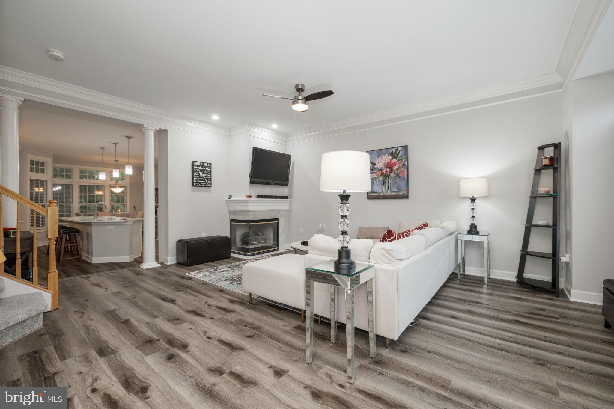 6337 Simmer Circle Springfield, VA 22150 - Photo 2 of 50 a living room with furniture a fireplace and a flat screen tv