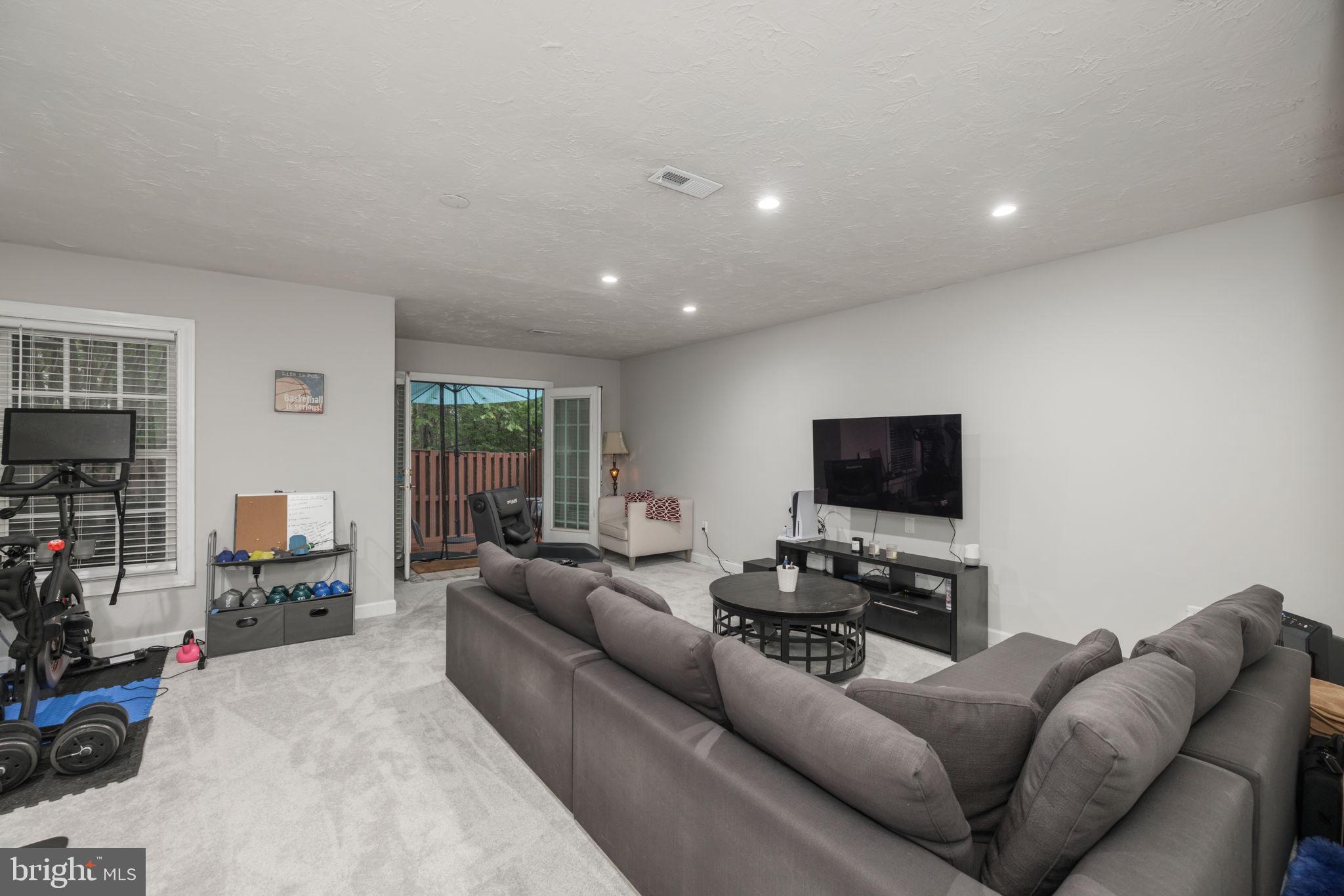 6337 Simmer Circle Springfield, VA 22150 - Photo 22 of 50 a living room with furniture and a flat screen tv