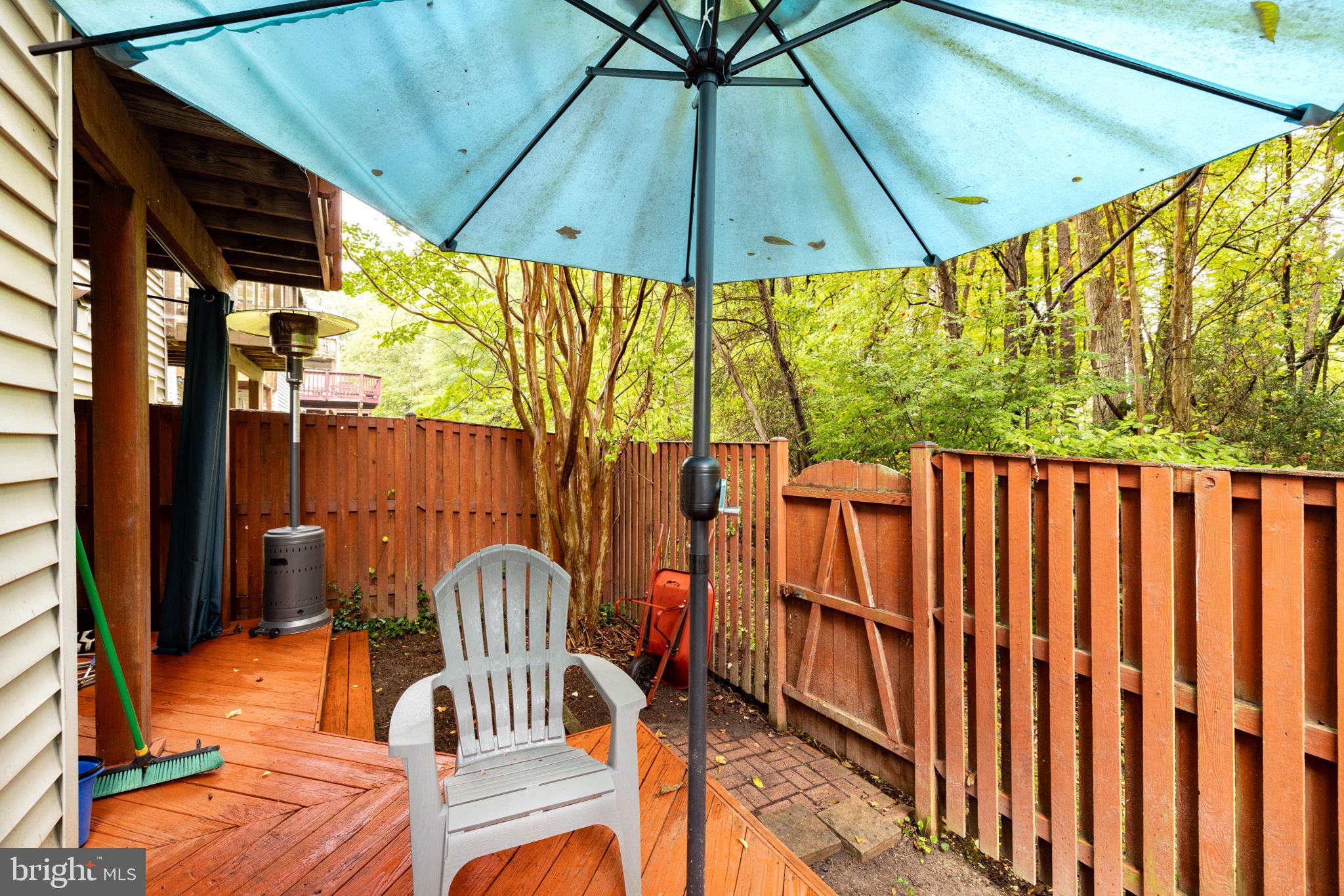 6337 Simmer Circle Springfield, VA 22150 - Photo 29 of 50 a view of a patio with a table and chairs under an umbrella