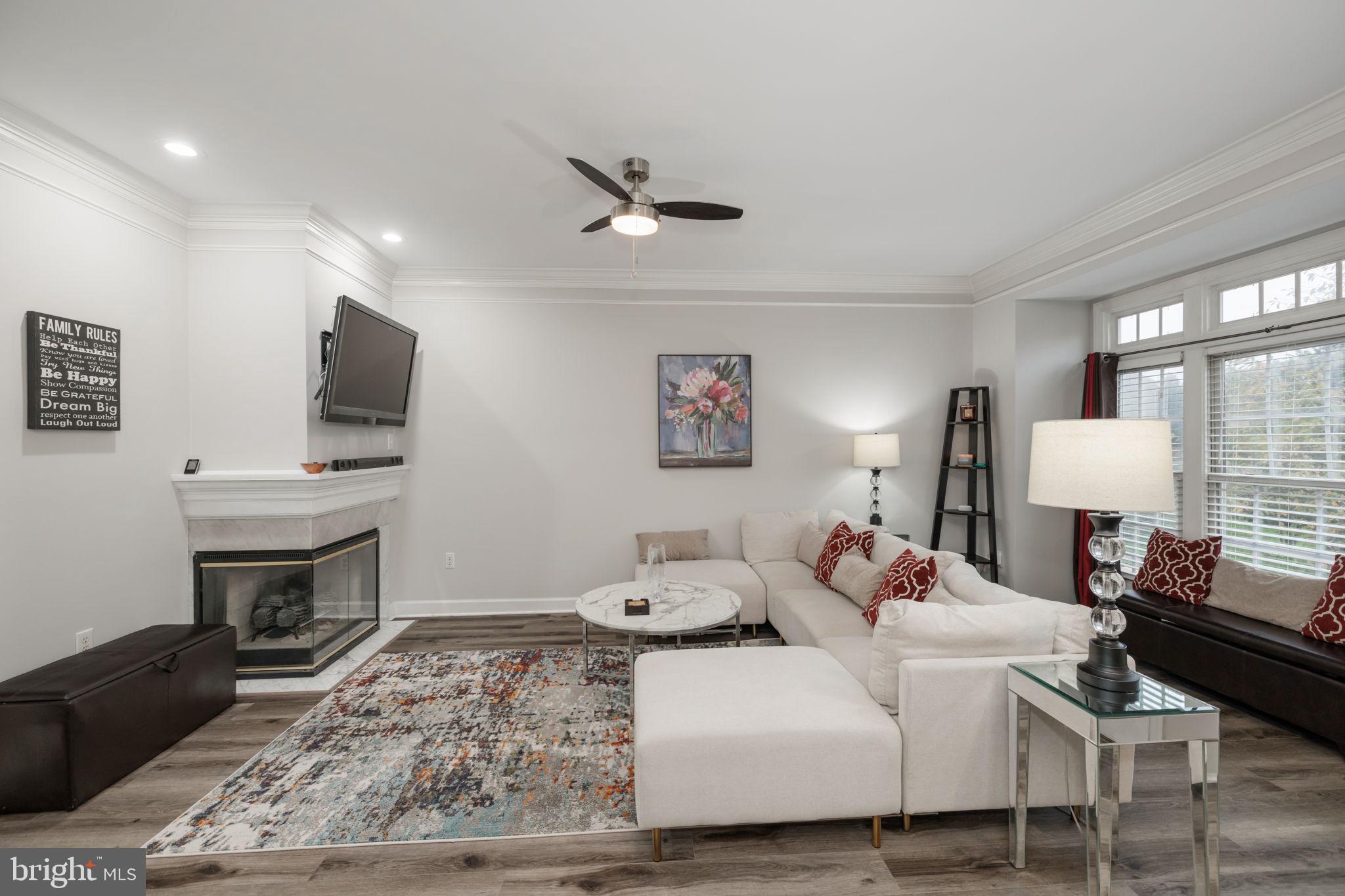 6337 Simmer Circle Springfield, VA 22150 - Photo 3 of 50 a living room with furniture a lamp and a flat screen tv