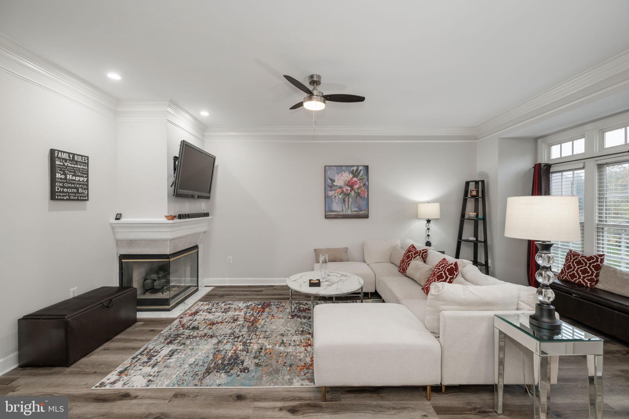 6337 Simmer Circle Springfield, VA 22150 - Photo 4 of 50 a living room with furniture a fireplace and a flat screen tv