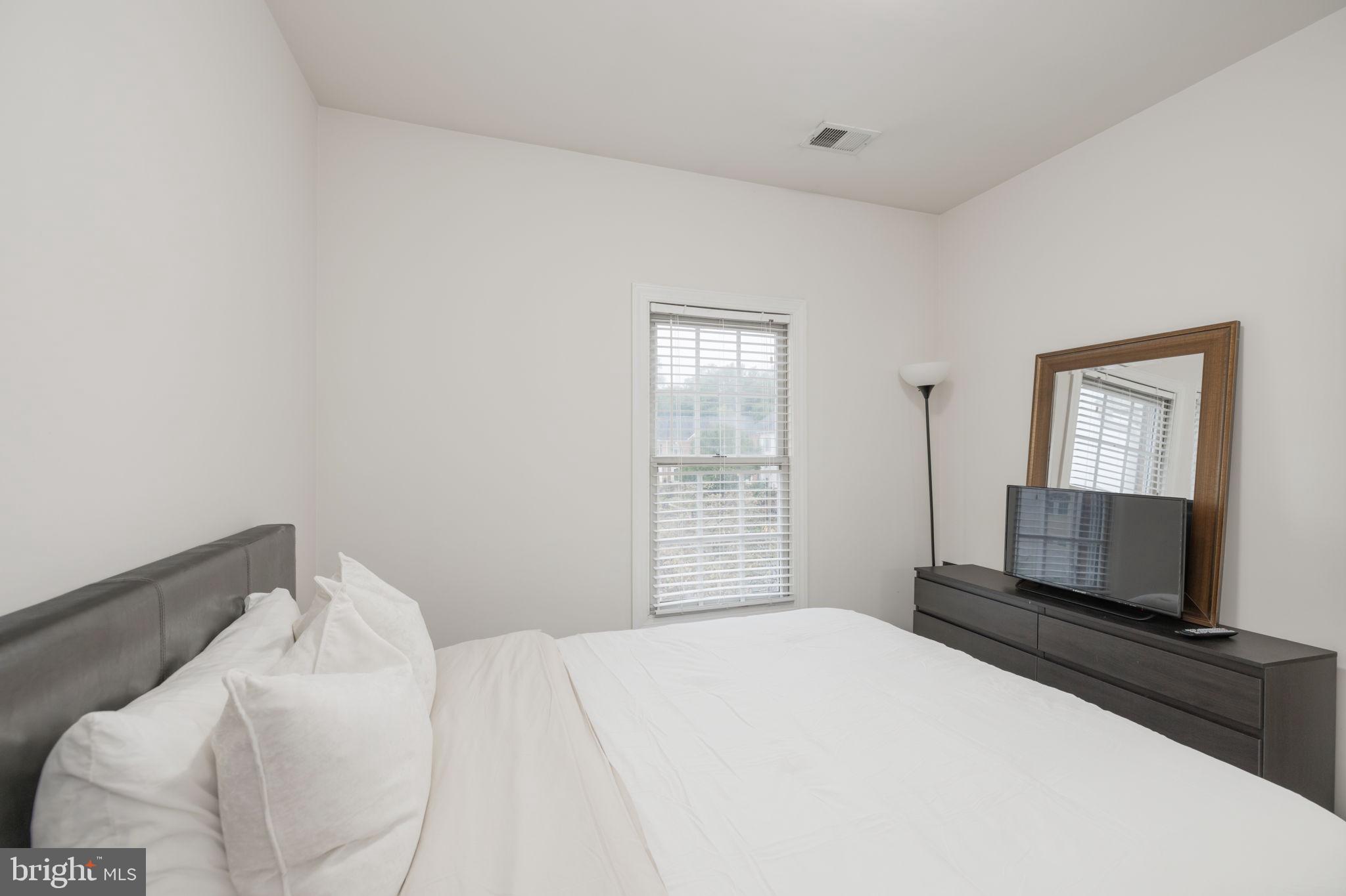 6337 Simmer Circle Springfield, VA 22150 - Photo 42 of 50 a bedroom with a bed and a flat screen tv