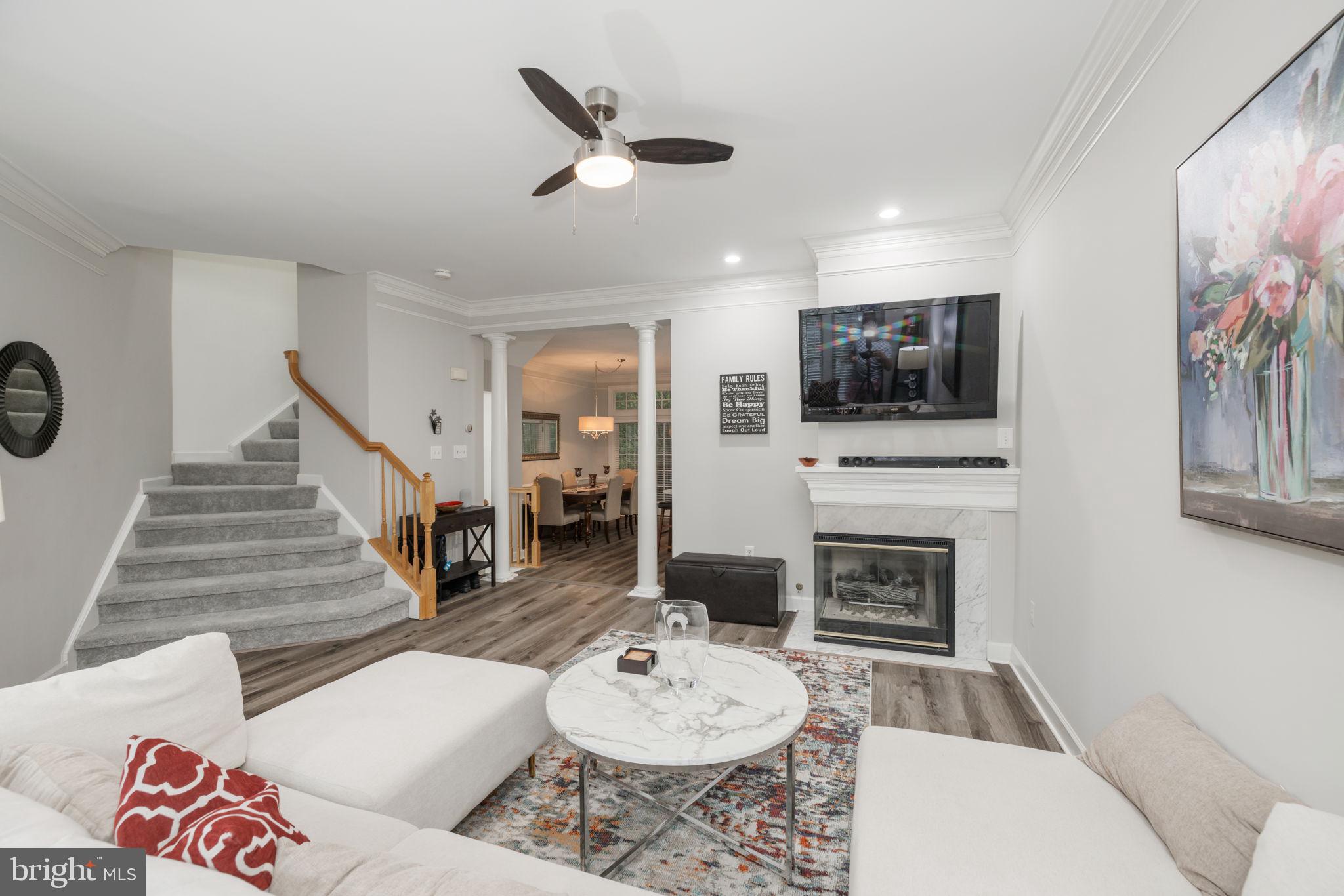 6337 Simmer Circle Springfield, VA 22150 - Photo 7 of 50 a living room with furniture a fireplace and a flat screen tv