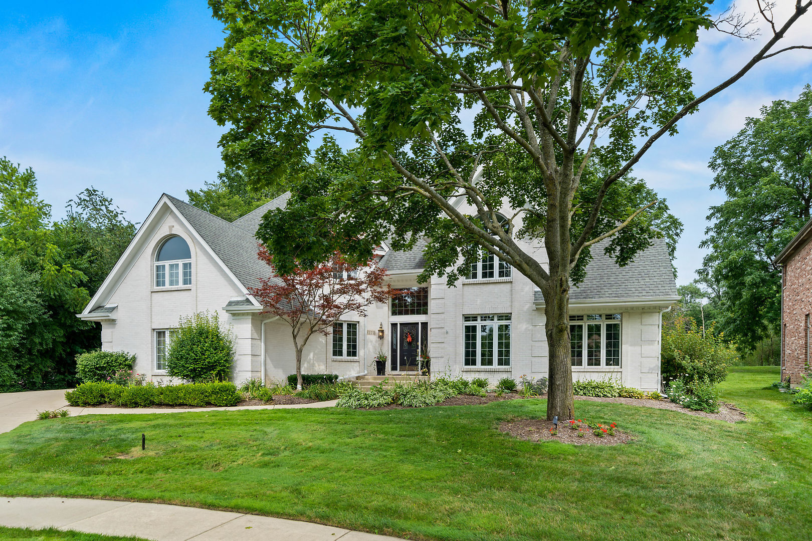 a front view of a house with a garden