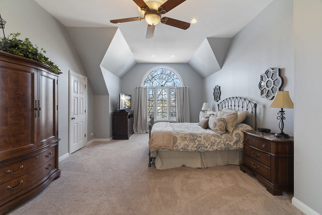 3111 Turnberry Road St. Charles, IL 60174 - Photo 16 of 34 a spacious bedroom with a bed and a chandelier