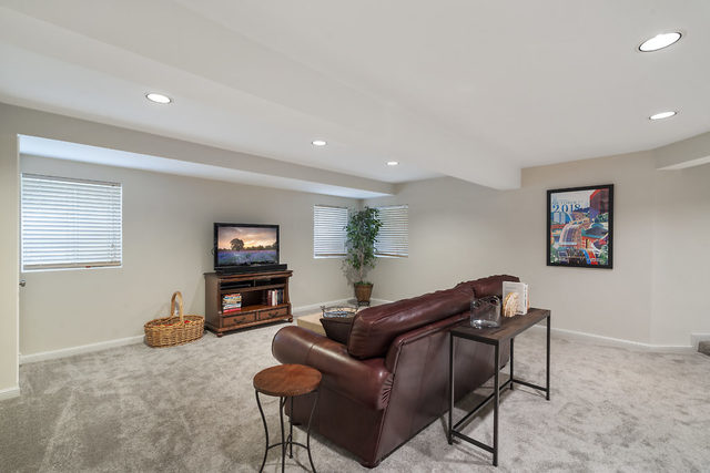 3111 Turnberry Road St. Charles, IL 60174 - Photo 24 of 34 a living room with furniture and a flat screen tv
