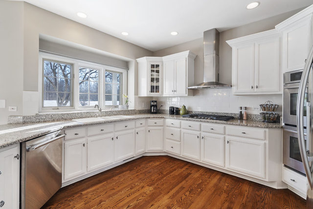 3111 Turnberry Road St. Charles, IL 60174 - Photo 6 of 34 a kitchen with granite countertop white cabinets and white appliances