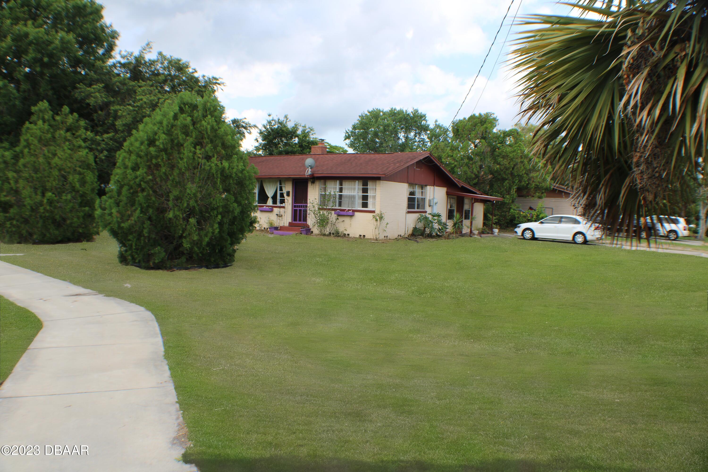 602 Flagler Avenue Edgewater, FL 32132 - Photo 1 of 15 a view of a house with a yard and sitting area