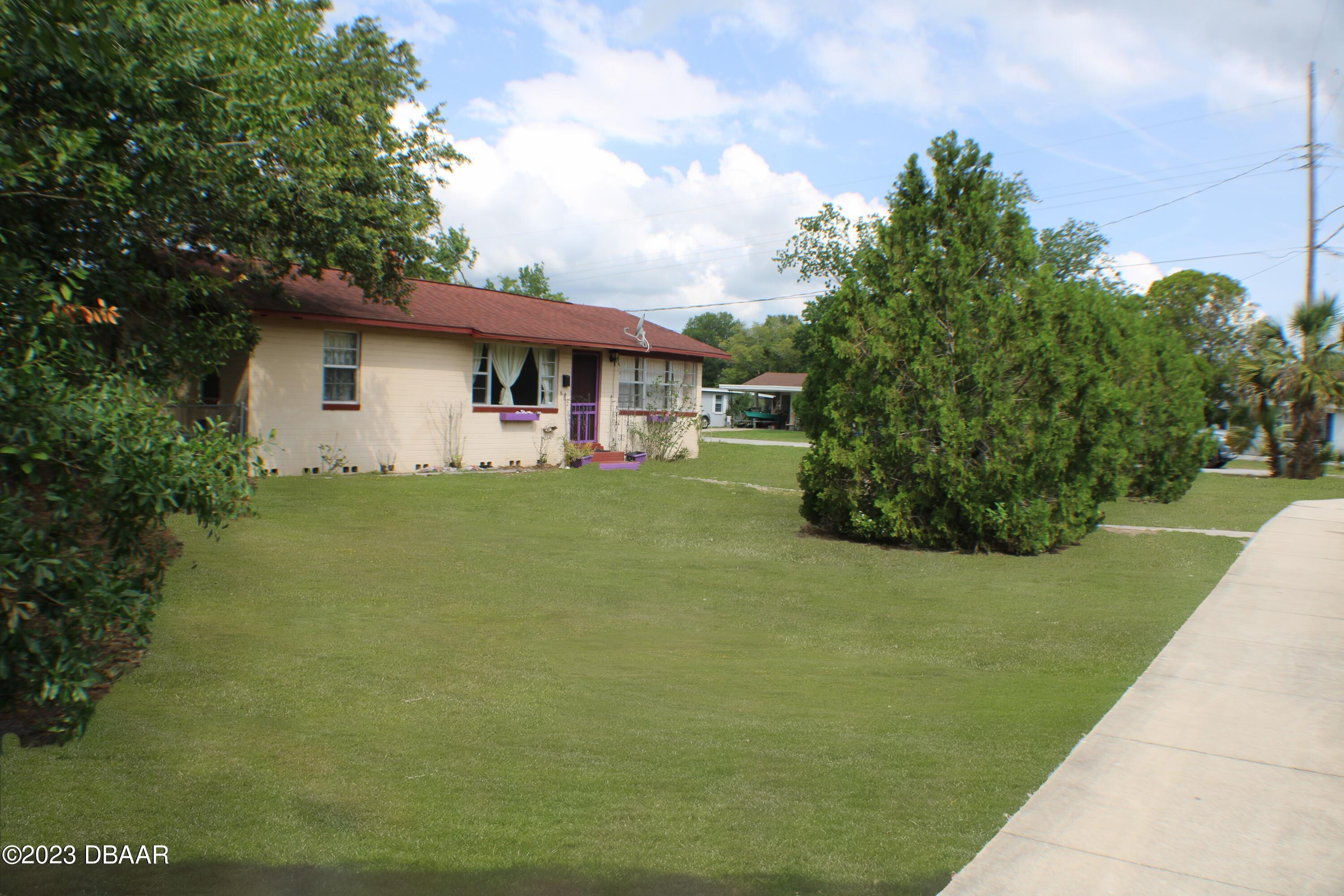 602 Flagler Avenue Edgewater, FL 32132 - Photo 3 of 15 a front view of a house with garden