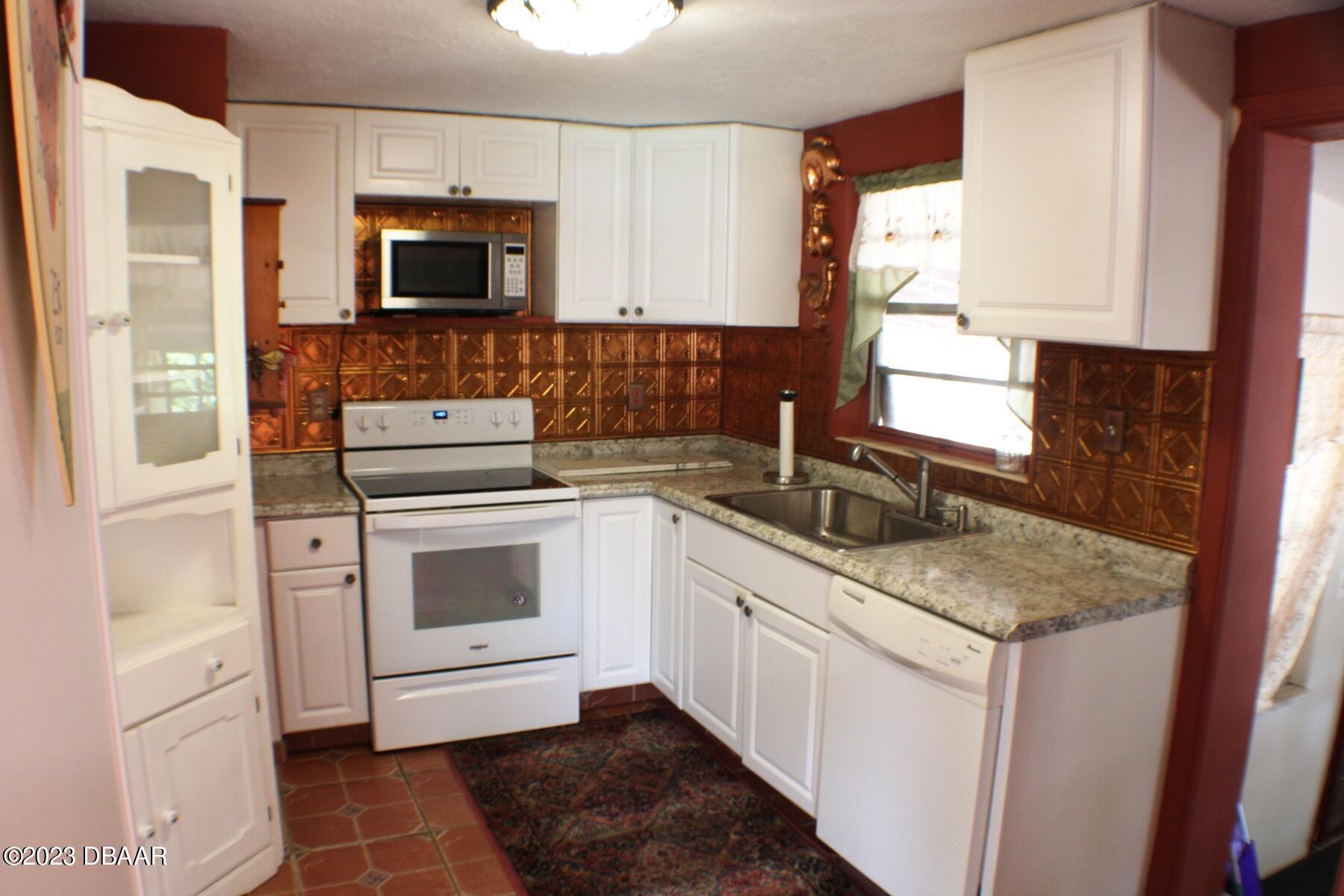 602 Flagler Avenue Edgewater, FL 32132 - Photo 7 of 15 a kitchen with a sink stove and microwave