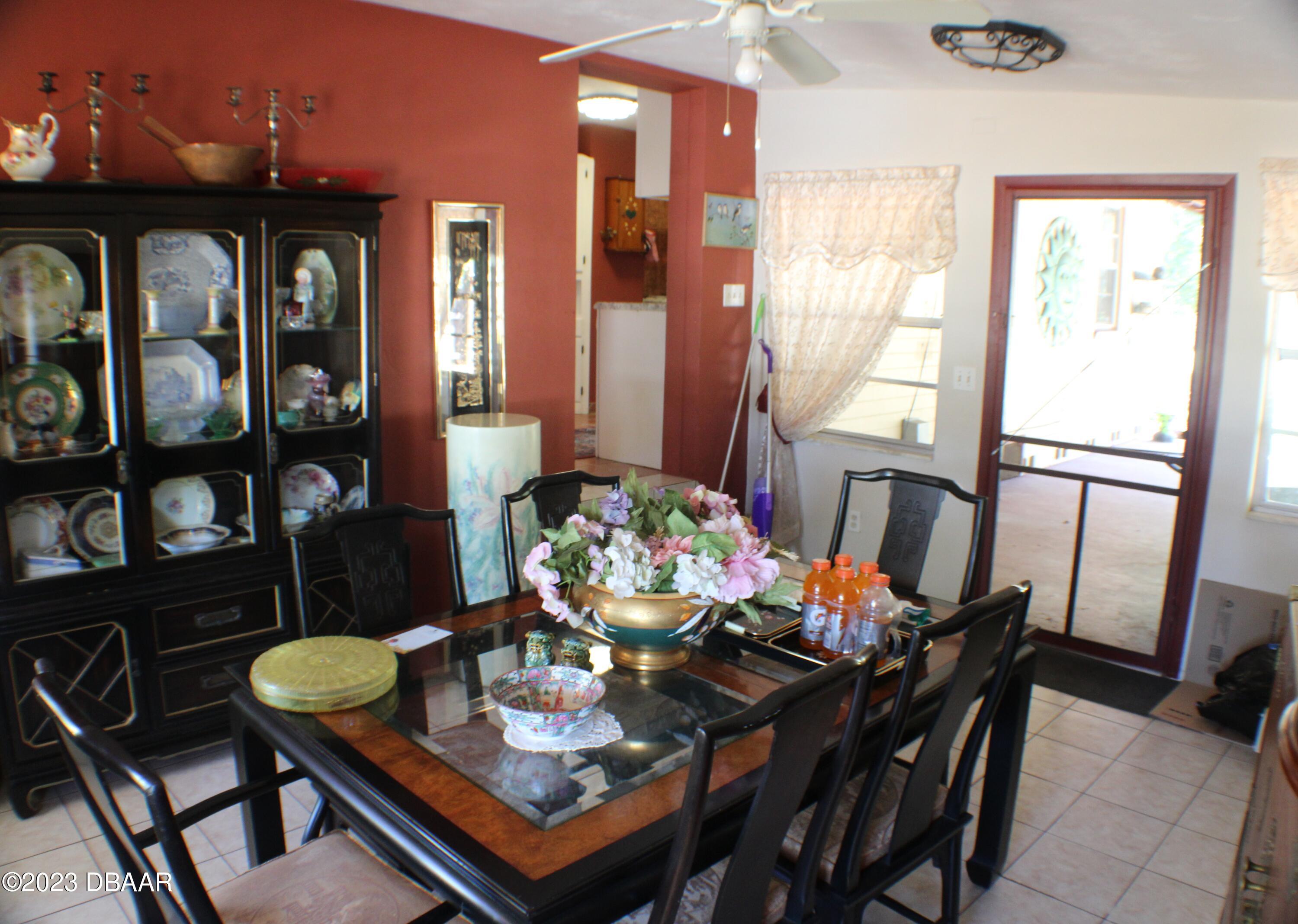 602 Flagler Avenue Edgewater, FL 32132 - Photo 9 of 15 a view of a dining room with furniture and a potted plant