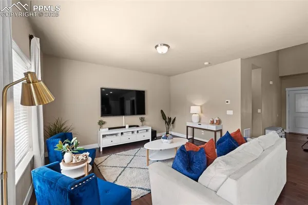a living room with furniture and a flat screen tv