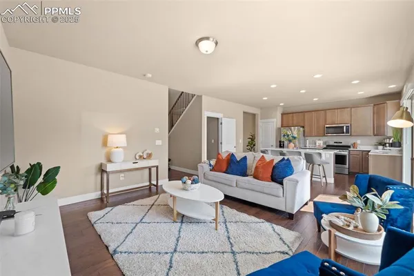 a living room with furniture kitchen view and a table