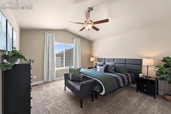 a spacious bedroom with a bed and a window