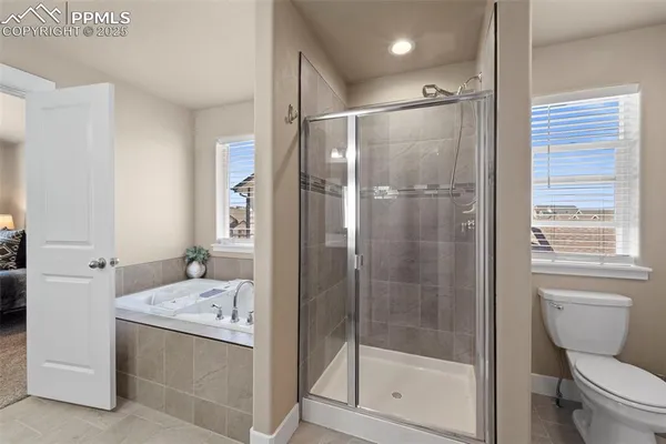 a bathroom with a shower a sink and toilet