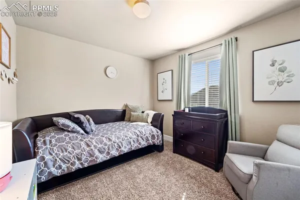 a bedroom with a bed and a couch