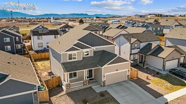 an aerial view of a house with a city view