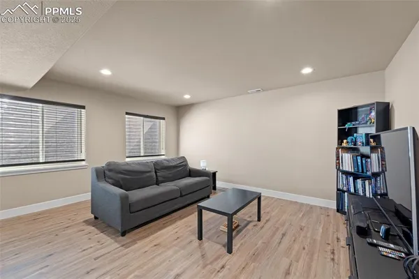 a living room with furniture and a wooden floor