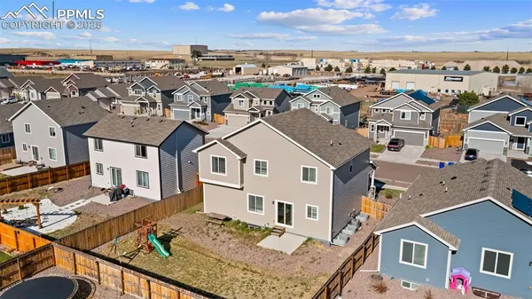 an aerial view of residential houses with outdoor space