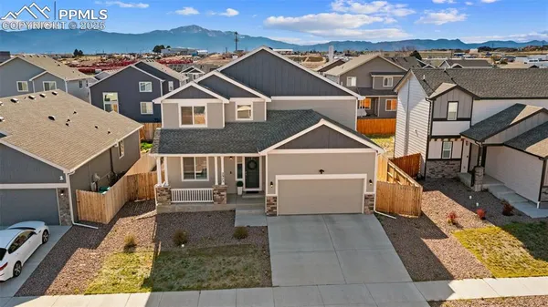 a view of a big house with a big yard